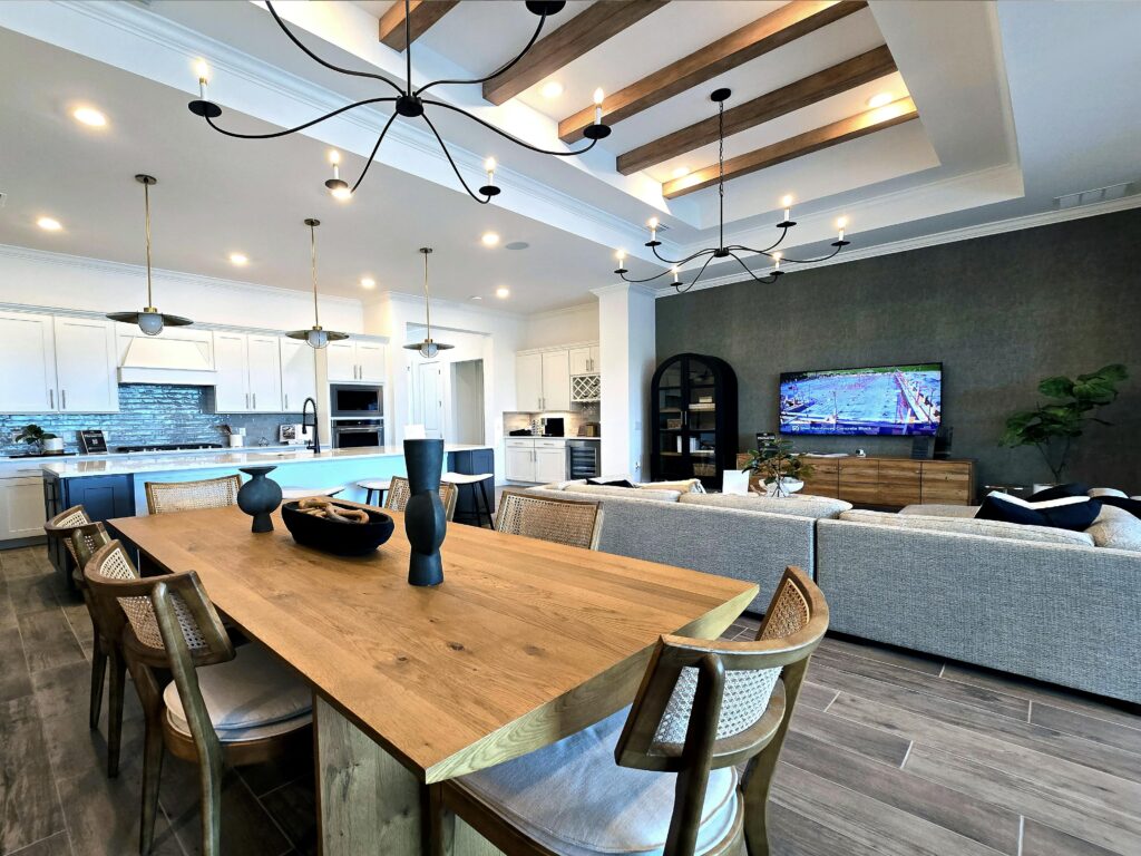 Elegant open-concept kitchen and living room with modern decor and ample natural lighting.